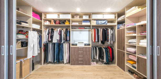 istock Big wardrobe with different clothes for dressing room 1164179742