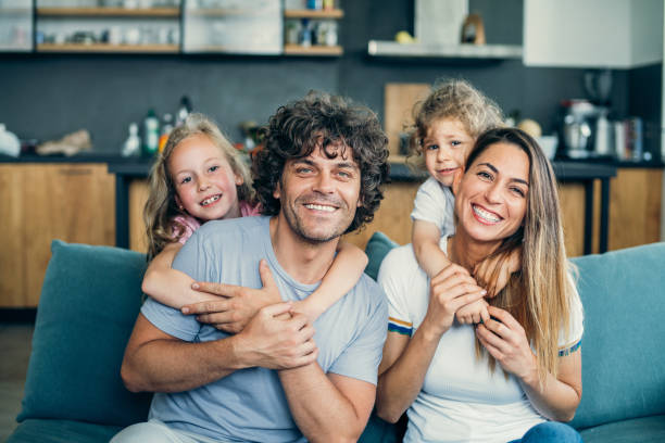 istock Happy parents with children at home 1164179775