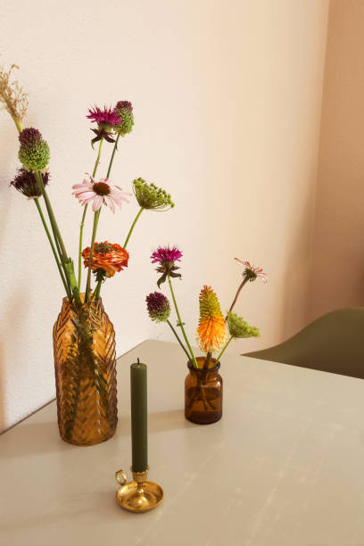 istock Two vases with flowers on the table retro modern design with white wall 1164179943