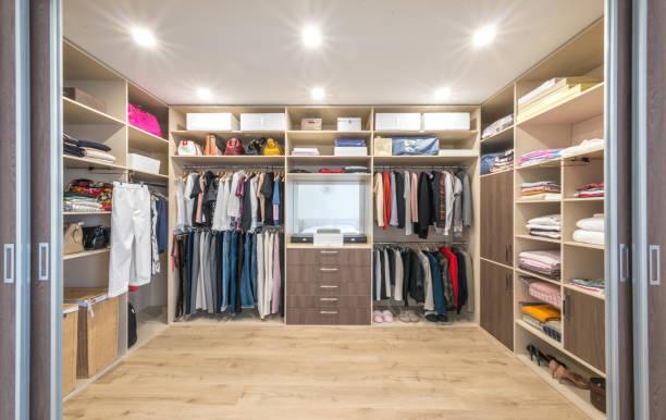 Big wardrobe with different clothes for dressing room Big wardrobe with different clothes for dressing room. Walk in closet cloakroom stock pictures, royalty-free photos & images