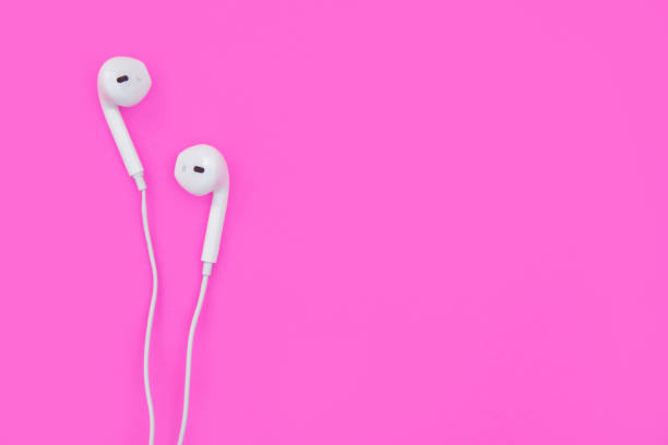 istock White earphones on pink background with copy space and clipping path. Flat lay. Top view. 1164180651