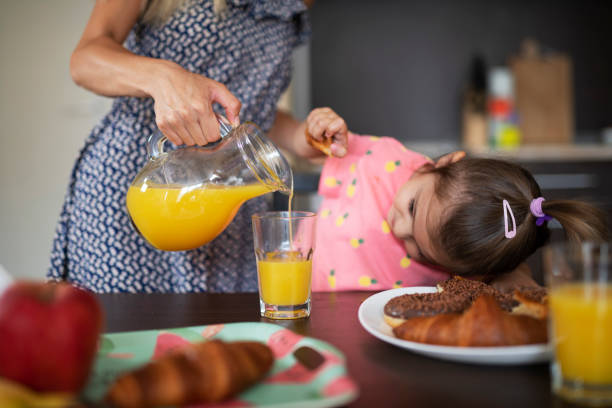 istock Mother and her daughter eating breakfast at home. 1164180788