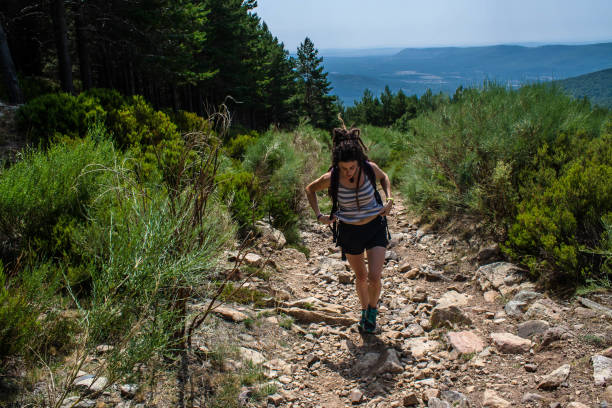 istock young woman make their way on the mountain 1164181015
