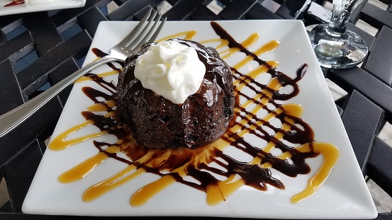 Oh so delicious chocolate lava cake with whipping cream and drizzled with chocolate and caramel syrups; fun desserts, chocolate, chocoholic ideas.