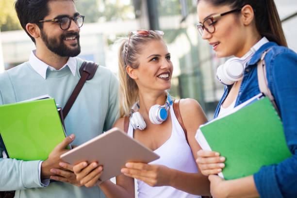 istock Group of friends studying together at university campus 1164182337