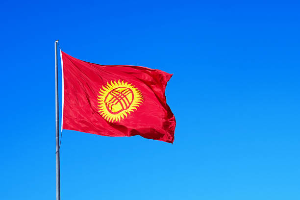 Kyrgyzstan flag on the mast Kyrgyzstan flag on the mast on deep blue sky background. Kyrgyz republic national flag kyrgyzstan photos stock pictures, royalty-free photos & images