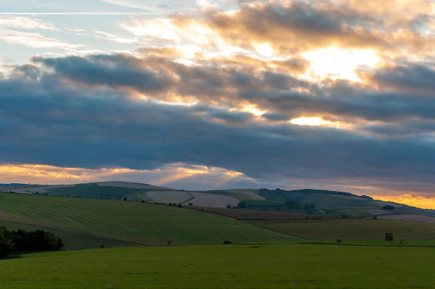 istock The sun setting over the fields of beautiful Wiltshire 1164186213