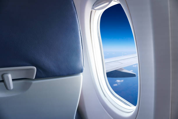 istock Wing airplane with blue sky and clouds from window 1164191118