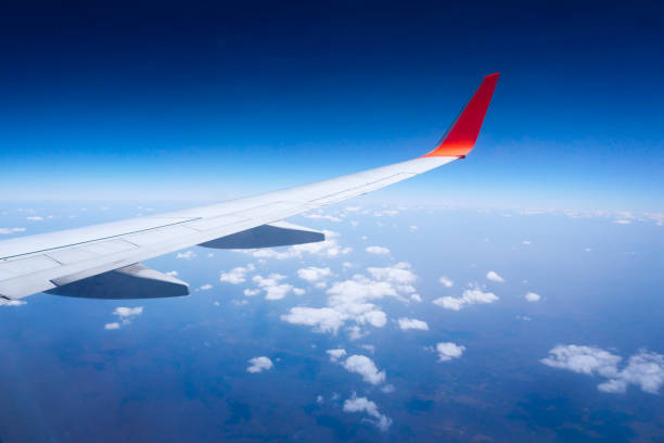 istock Wing airplane with blue sky and clouds from window 1164191121