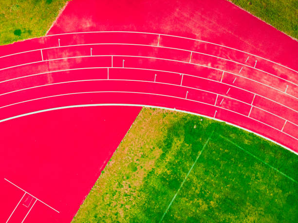 stadium with green grass and red running line