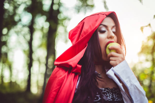 istock Little red riding hood eating an apple 1164194934