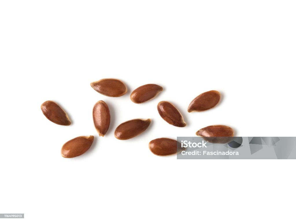 flax seed linseed pile isolated on white top view Extreme close up of flax seeds isolated on white background. Linseed pile closeup isolated on white with clipping path. Top view or flat lay. Macro shot Flax Seed Stock Photo