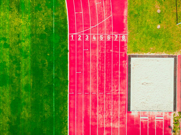 stadium with green grass and red running line