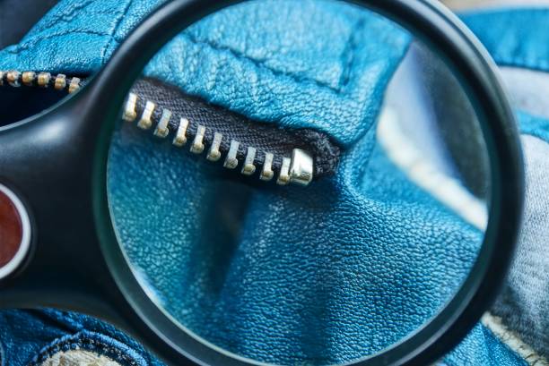magnifier increases metal zip on blue leather clothes black magnifier increases metal zip on blue leather clothes leather clasp stock pictures, royalty-free photos & images