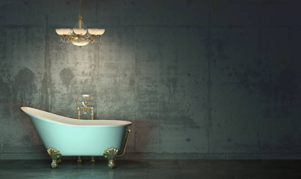 dark room in the twilight with classic style bath and chandelier with gold-plated elements standing on the floor  in front of the concrete wall. gloomy interior in loft style with copy space. 3d rendering. - gold plated imagens e fotografias de stock