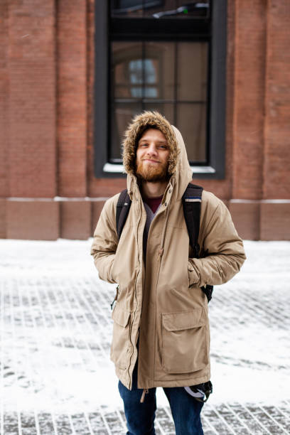 istock A bearded young man walks on winter street 1164198374
