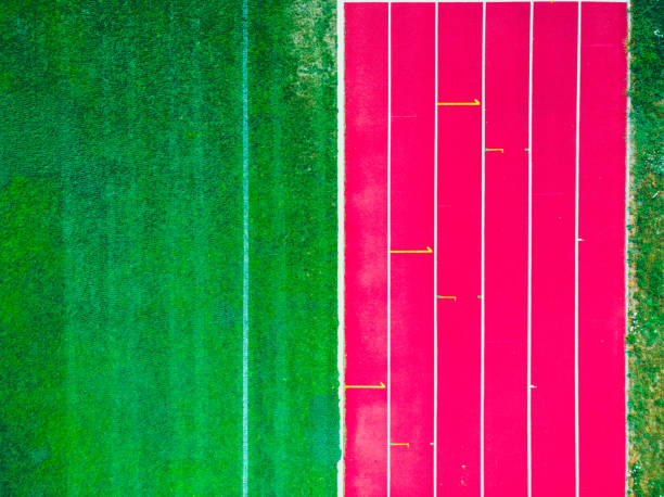 stadium with green grass and red running line