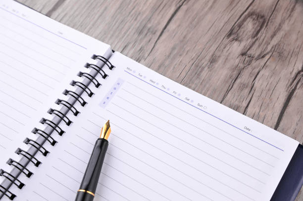 istock Notebook with fountain pen on wooden table 1164200482