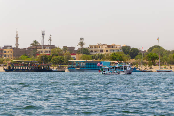 Tourists on ships look around the sights of the city of Luxor. Tourists boats on the River Nile and  on the background old building