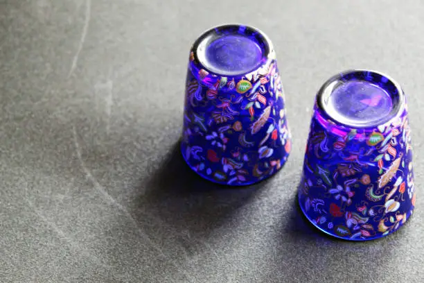 Inverted souvenir cups with vivid colors and intricate decorations used as a ​showpiece