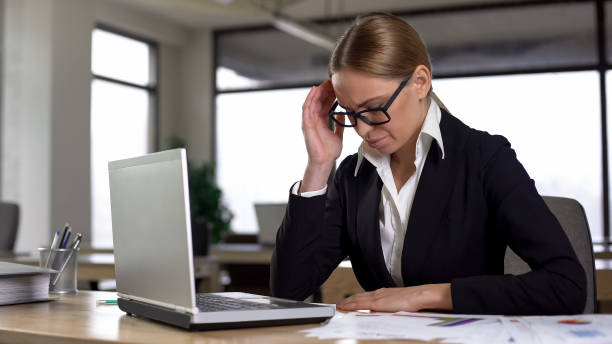istock Businesslady suffering headache working in office, worried about complex project 1164202981