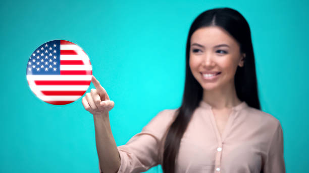 istock Cheerful female student pushing USA flag button, ready to learn foreign language 1164204370
