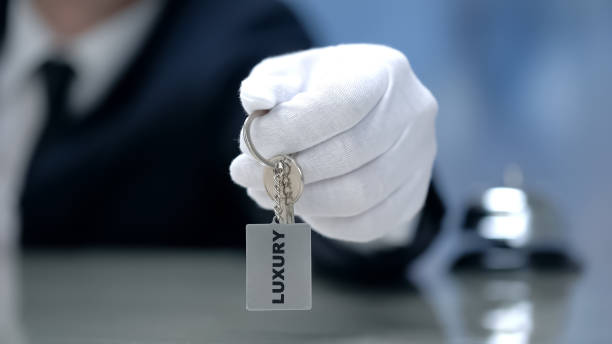istock Luxury written on keychain in receptionist hand, premium quality hotel, closeup 1164204476