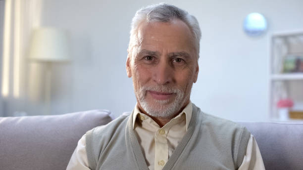 istock Happy elderly man smiling into camera, healthy and secure old age, wellness 1164204483