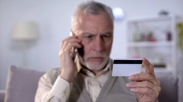 istock Annoyed old man talking by cellphone with bank support service about credit card 1164204778