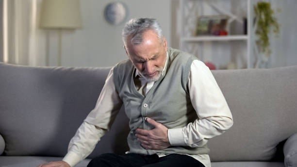 Old male having strong abdominal ache, stomach ulcer disease, health problems Old male having strong abdominal ache, stomach ulcer disease, health problems hernia photos stock pictures, royalty-free photos & images