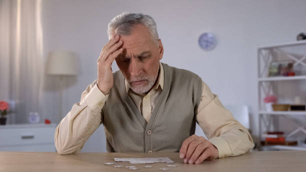 Pensioner trying to combine puzzle, having memory problems, cognitive impairment Pensioner trying to combine puzzle, having memory problems, cognitive impairment deterioration stock pictures, royalty-free photos & images