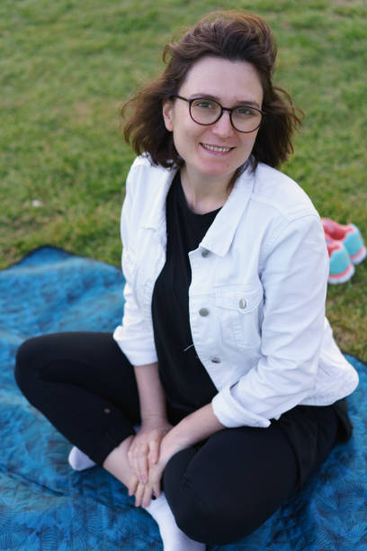 istock Smiling glasses girl in park 1164205893