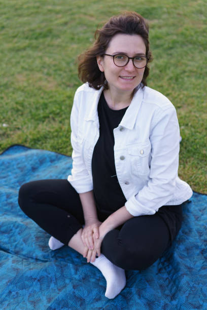 istock Smiling glasses girl in park 1164205940