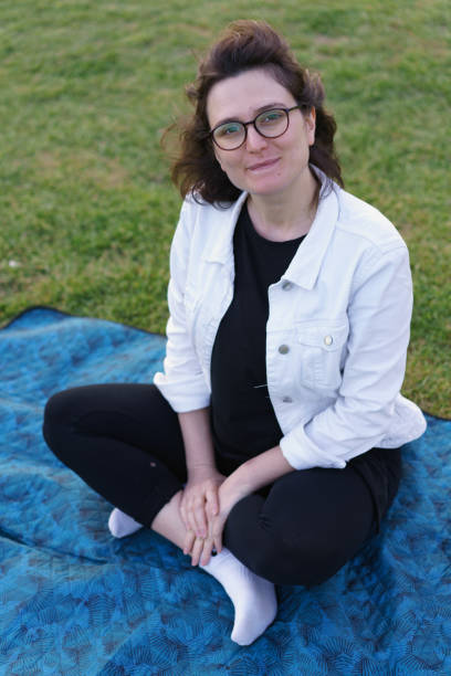 istock Smiling glasses girl in park 1164206165