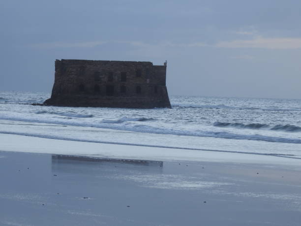 Casa Del Mar. The Atlantic ocean, the Cape Juby, Morocco. The ruined fortress, a tide, sand beach ,sea house .