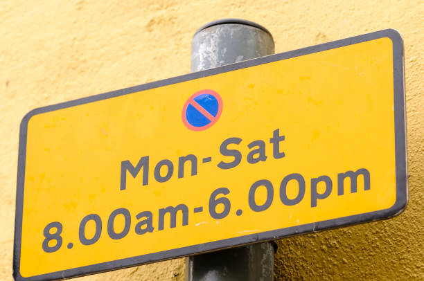 istock Restricted parking sign, showing parking is not permitted Monday to Saturday between 8am and 6pm 1164209891