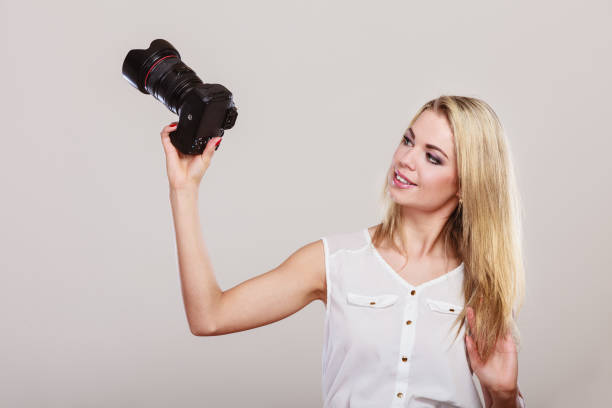 istock Beautiful woman with camera. 1164212427