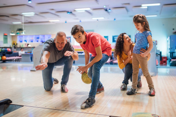 istock Boy bowling with family 1164212918