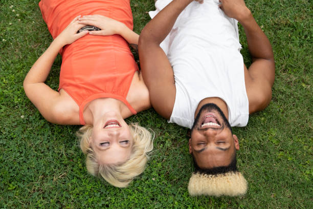istock A couple lay in the grass 1164213089