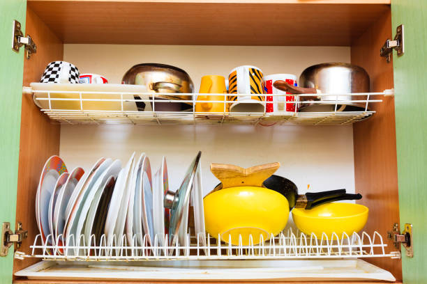 Housework, hygiene and cleaning concept. Dirt at home. Dirty filthy drainer with clean dishes in kitchen.