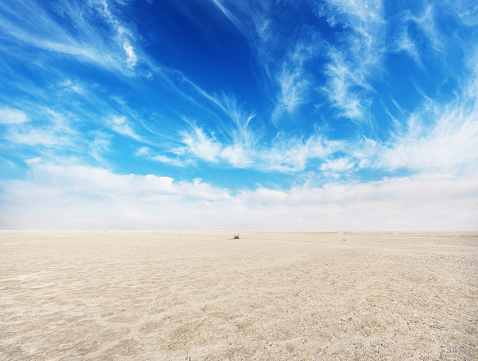 Desert with cloudy blue sky