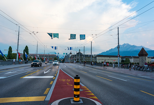Mont Blanc bridge and Swiss flags on road in Geneva, Switzerland