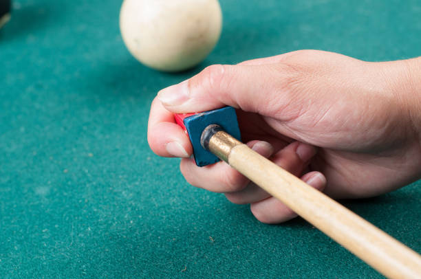 istock Cue stick with chalk block on green billiard table.Chalk block on pool table. 1164218189