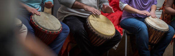 istock Group of people playing on drums 1164218908
