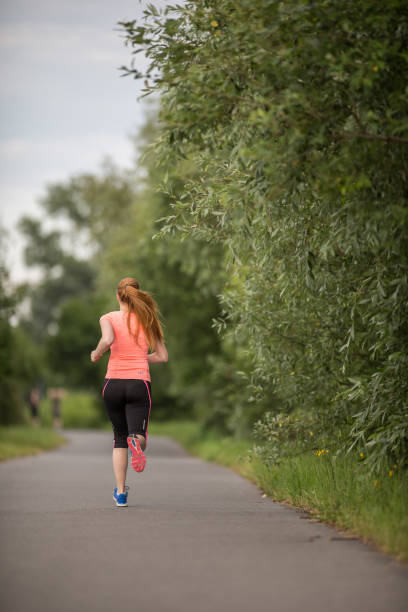 istock Young woman running outdoors 1164219076