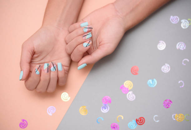 istock Beautiful female manicure on bed background with sparkles 1164220300