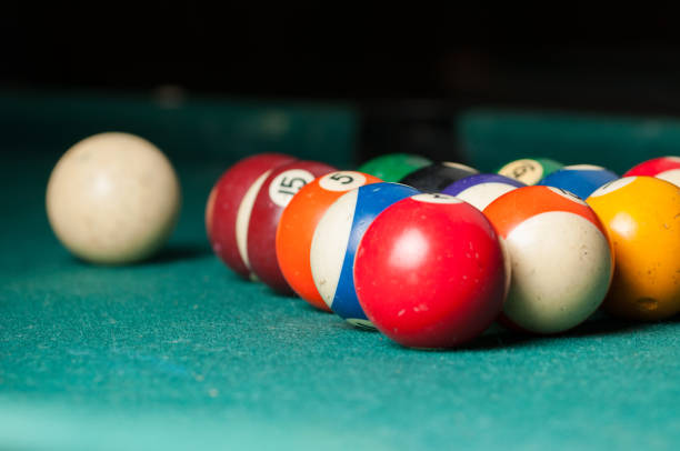 istock Old billiard balls on a green table. billiard balls isolated on a green background 1164221902