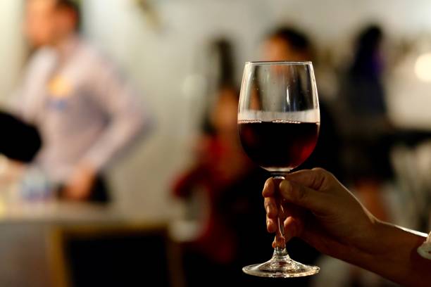 istock close up one hand holding a red wine glass 1164222990