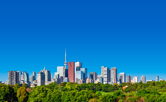 Looking west at the Toronto, Canada city skyline on a clear day at morning sunrise.