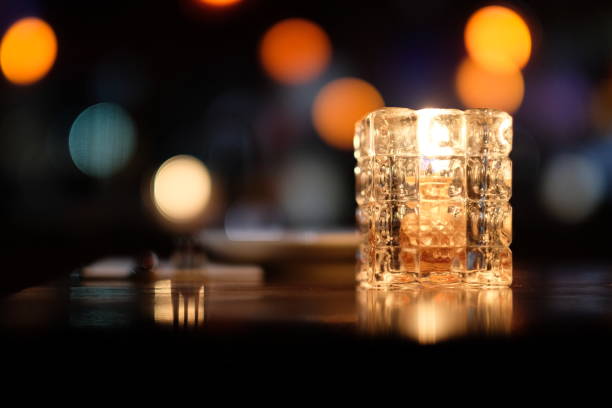 Colorful defocused illuminations, plate and fork. Black background. Bar and restaurant concept